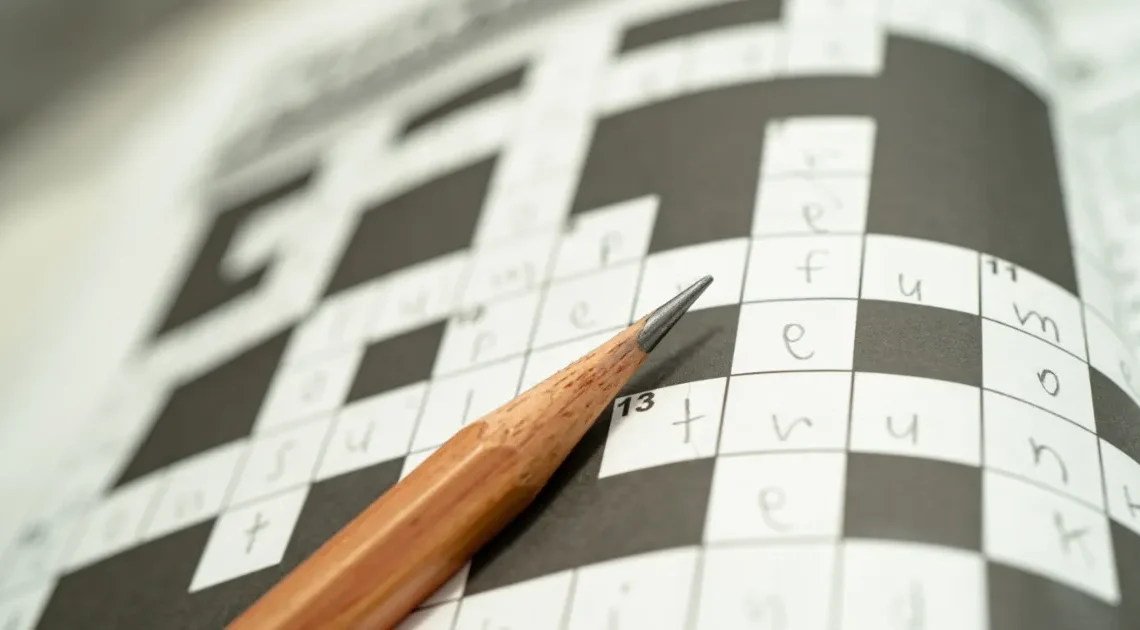 Pencil resting on puzzle grid for Hawaii and Tennessee NYT crossword clue