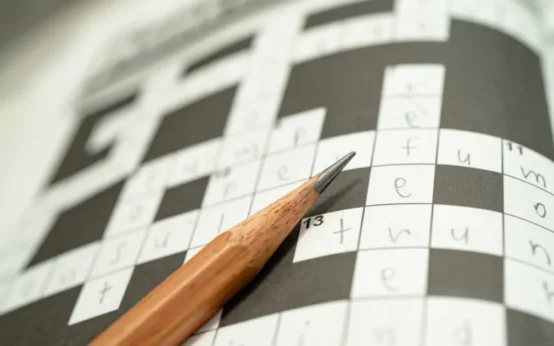 Pencil resting on puzzle grid for Hawaii and Tennessee NYT crossword clue