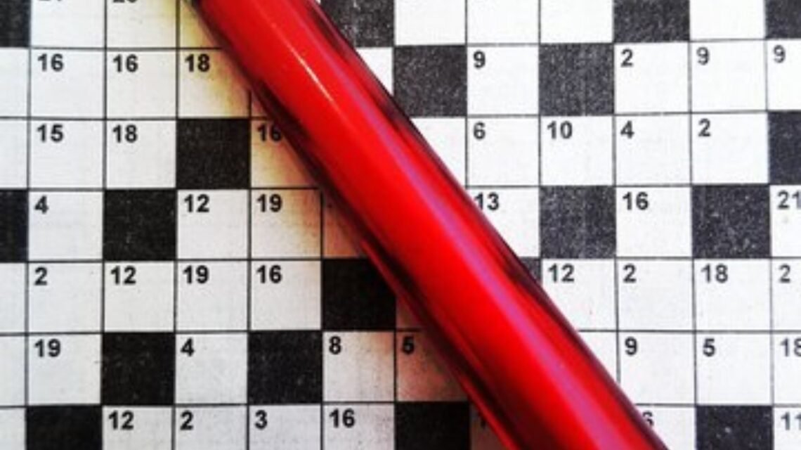 Red pencil on a NYT crossword puzzle grid with numbered clues, focusing on the 'Vault Opener NYT Crossword.